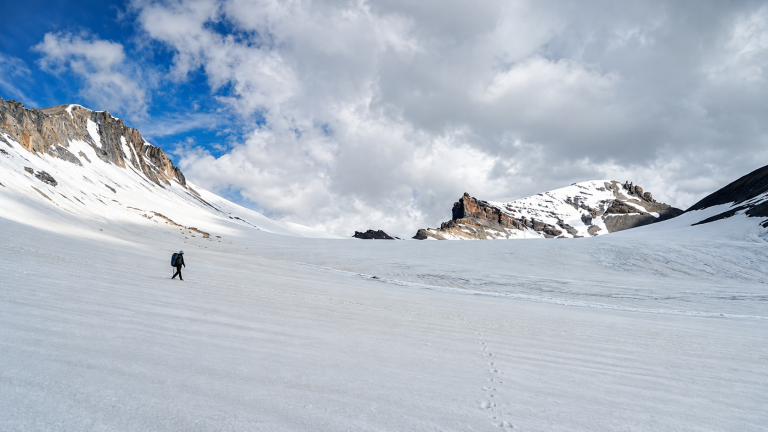 Trekker crossing the glacier below Parang La in the Himalayas